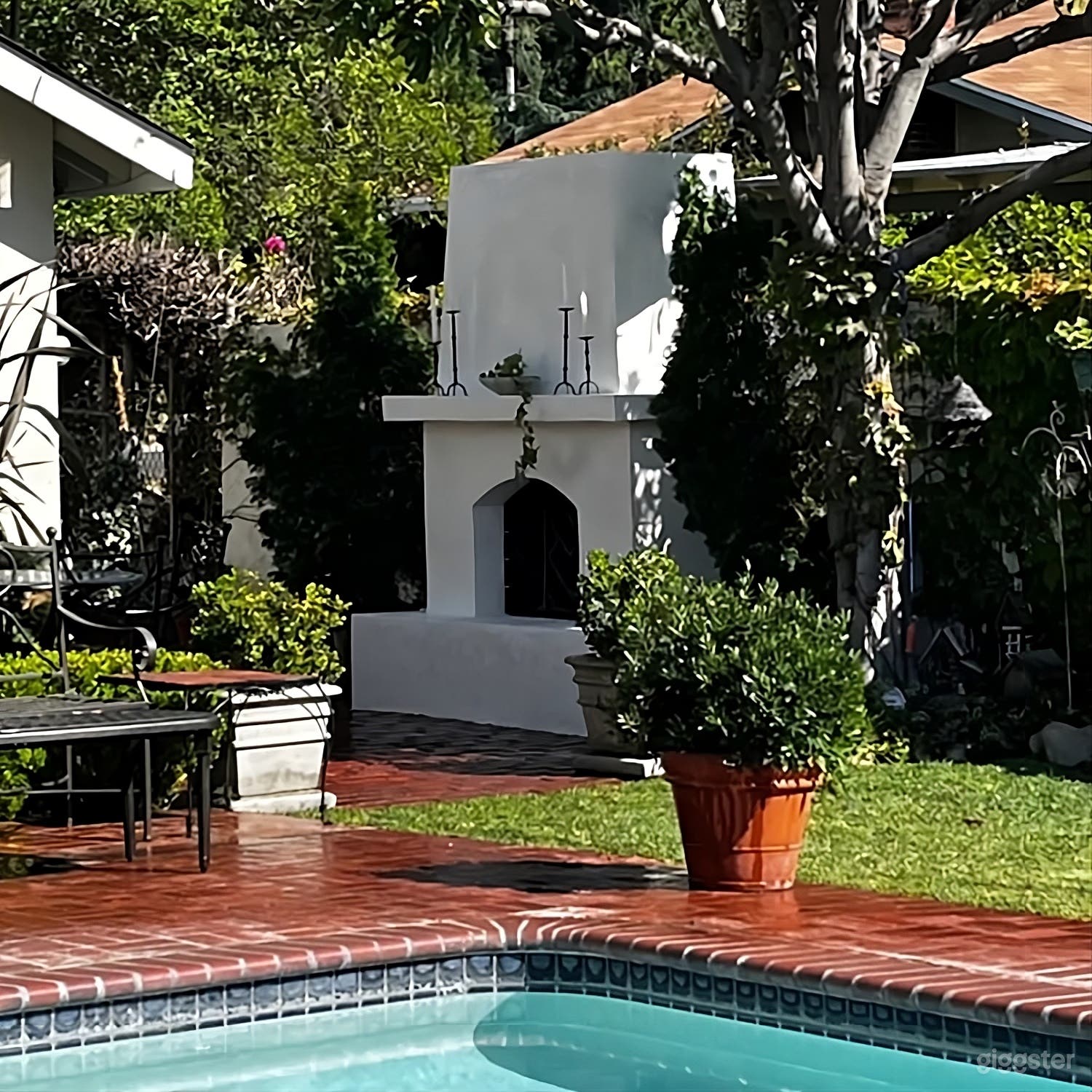 Lush Garden Backyard with Outdoor Fireplace Photo 3