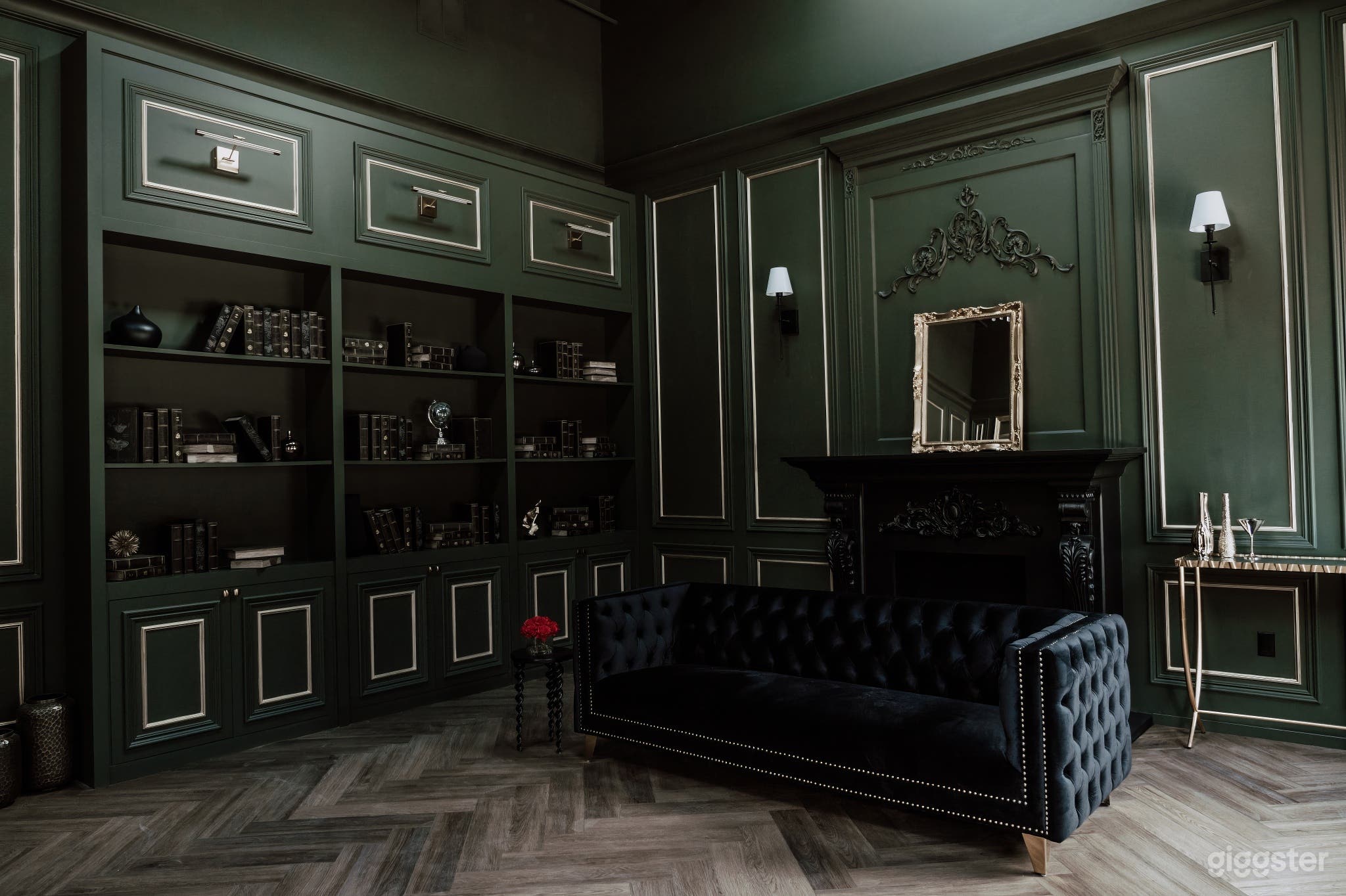 Rich and luxurious dark green room with black and gold accents and dark-themed furniture, evoking opulence and sophistication in our elegant studio space.