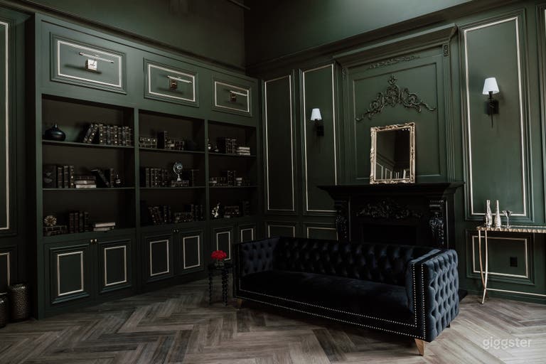  Rich and luxurious dark green room with black and gold accents and dark-themed furniture, evoking opulence and sophistication in our elegant studio space. 