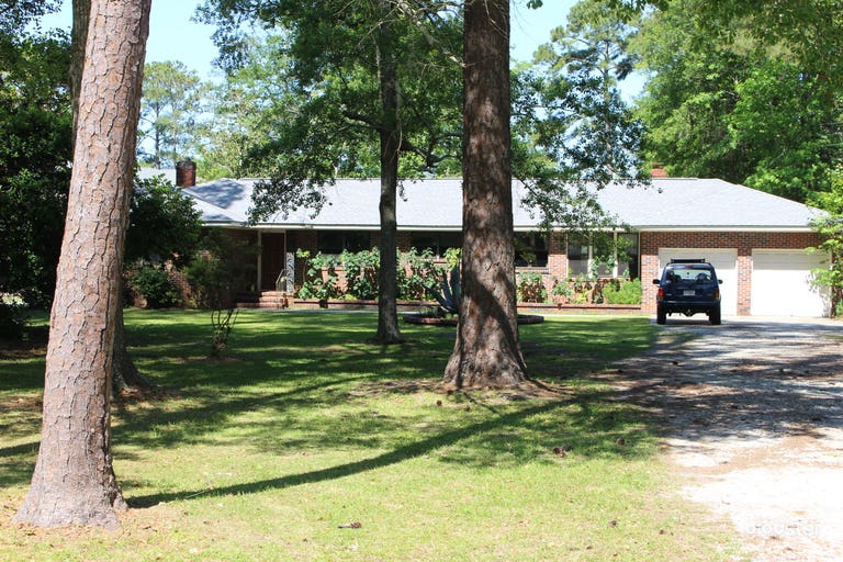  Mid-Century Brick Home on Expansive Riverfront Lot with Dock 