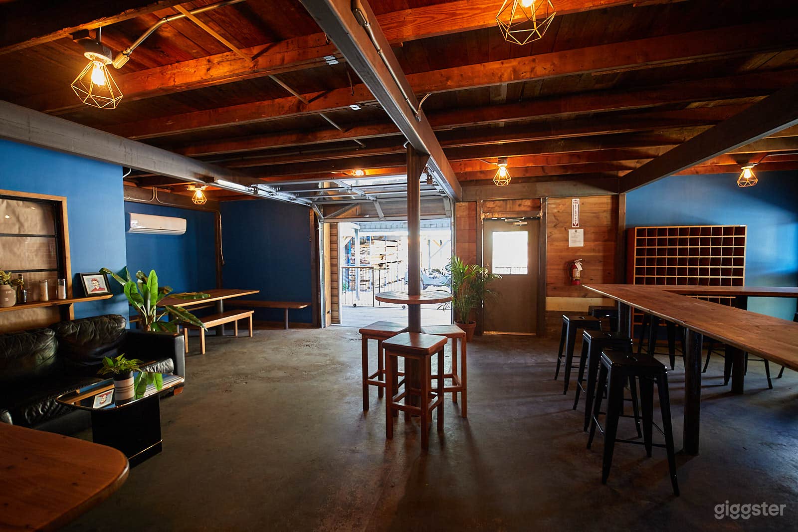 The Tropical Cantina is an intimate, eclectic gathering space with wrap around bar, community table, glass roll up and covered porch.
