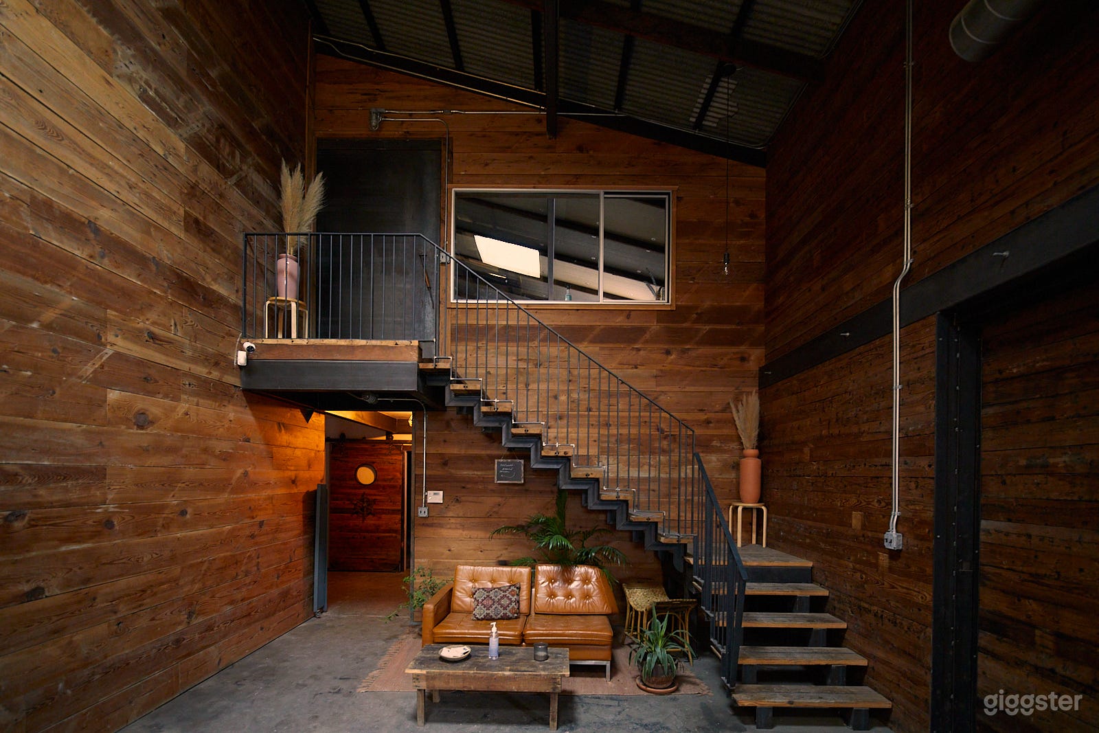 St. John Studio features salvaged wood walls, exposed steel beams, concrete floors, and high ceilings. A main great hall connects two unique bar areas, a loft/stage, and two production studios.
