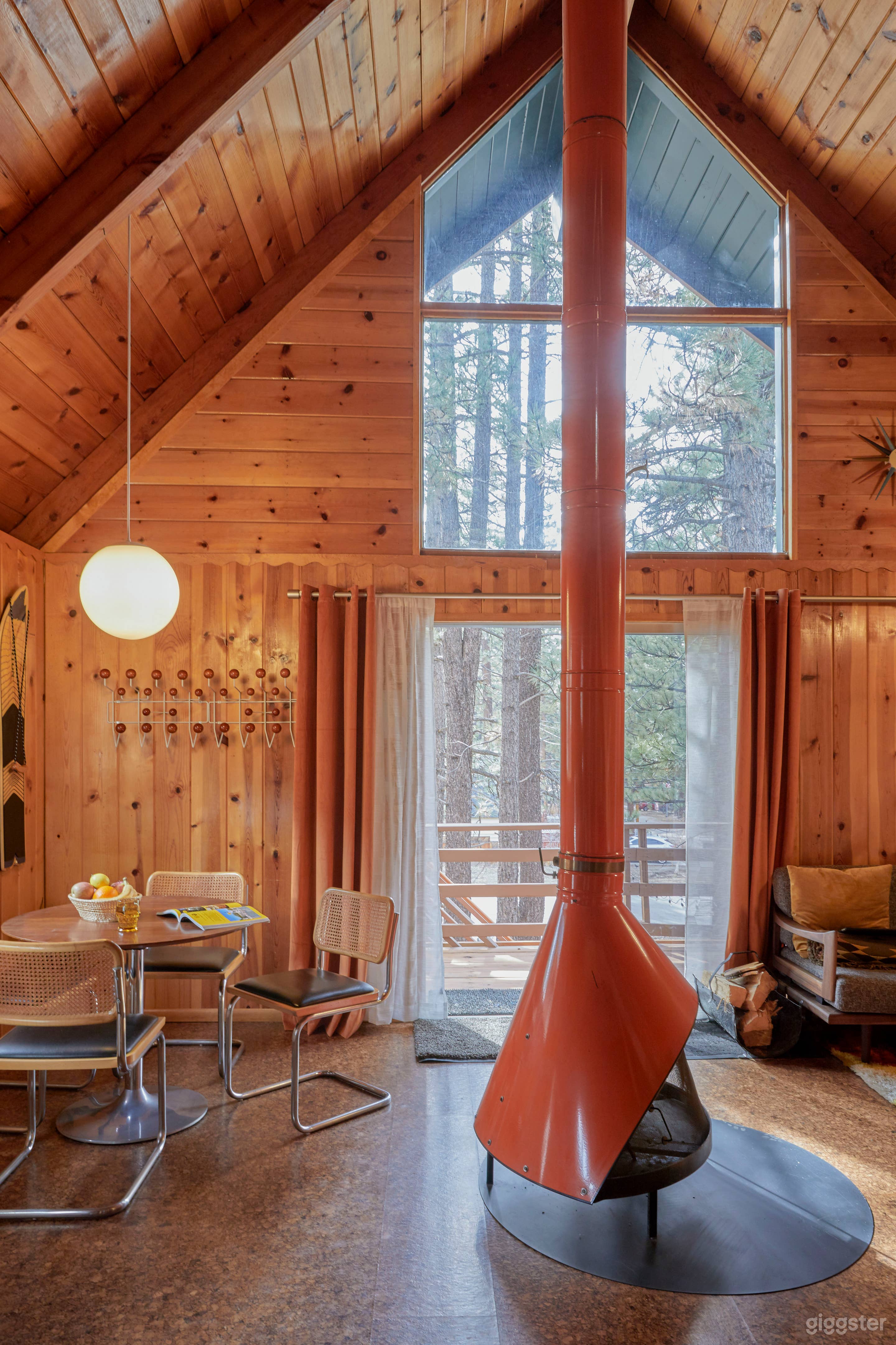 Mid Century cabin with fireplace in the middle.  Photo 2