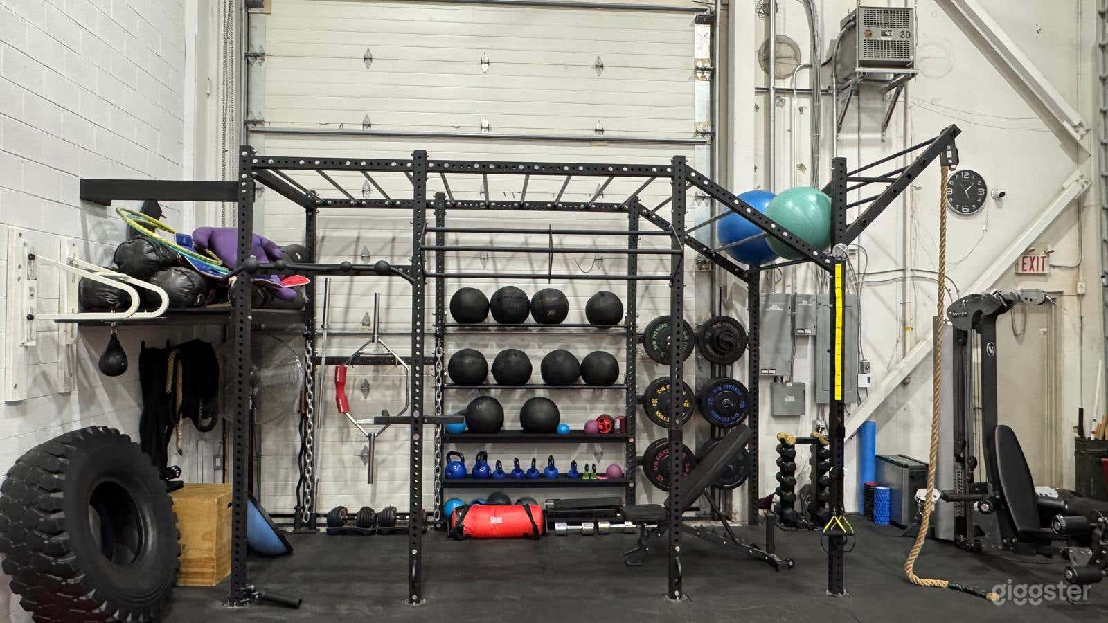 Weight/Crossfit training area including Boxing Speed bag, 200lb tire, free weights, dumbbells, kettle bells, stability and medicine balls, climbing rope and universal machine, plyo boxes, ab and foam rollers, 