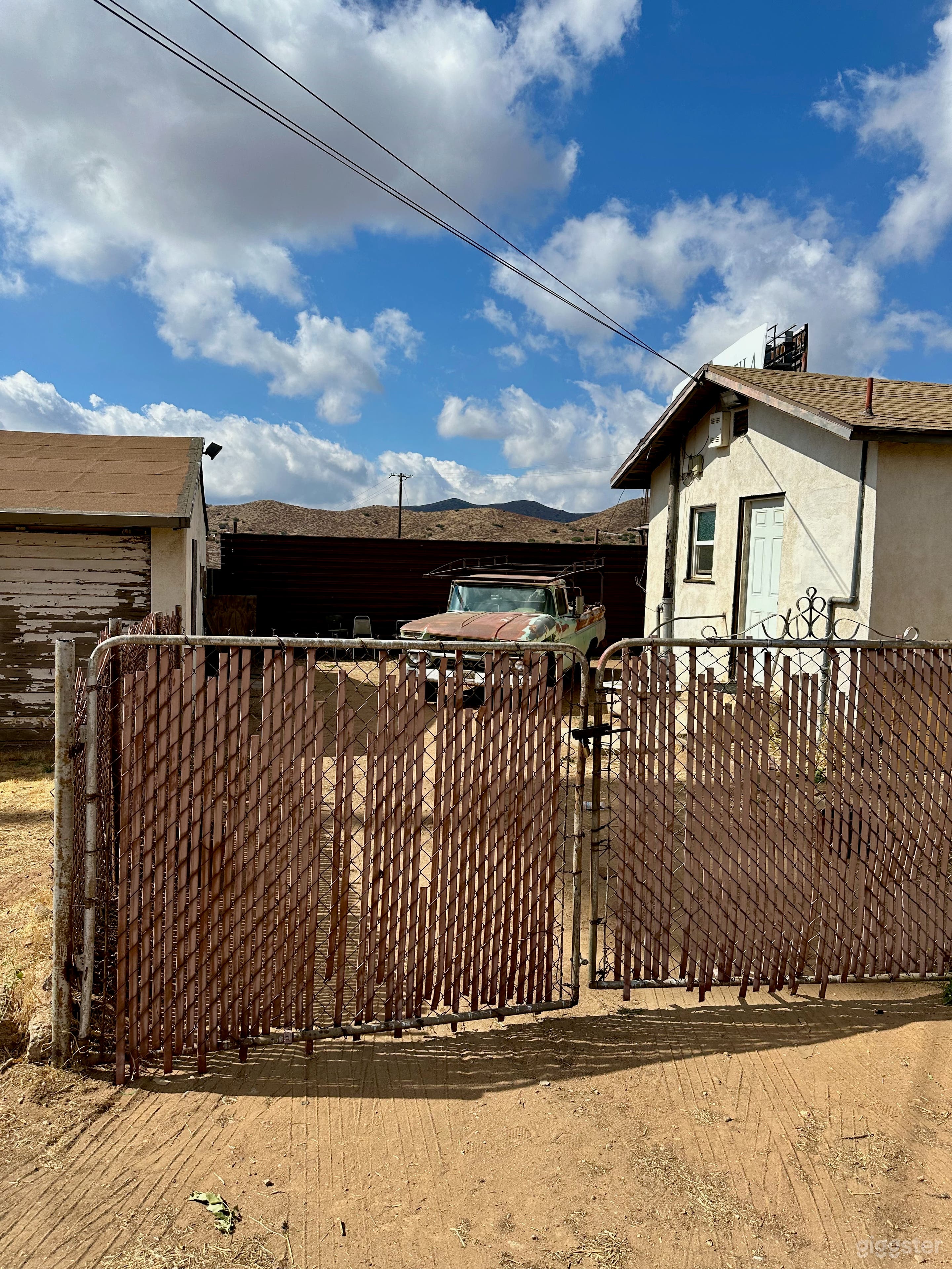 East side of house in our gated side yard between house and detached garage with 1963 GMC pickup parked