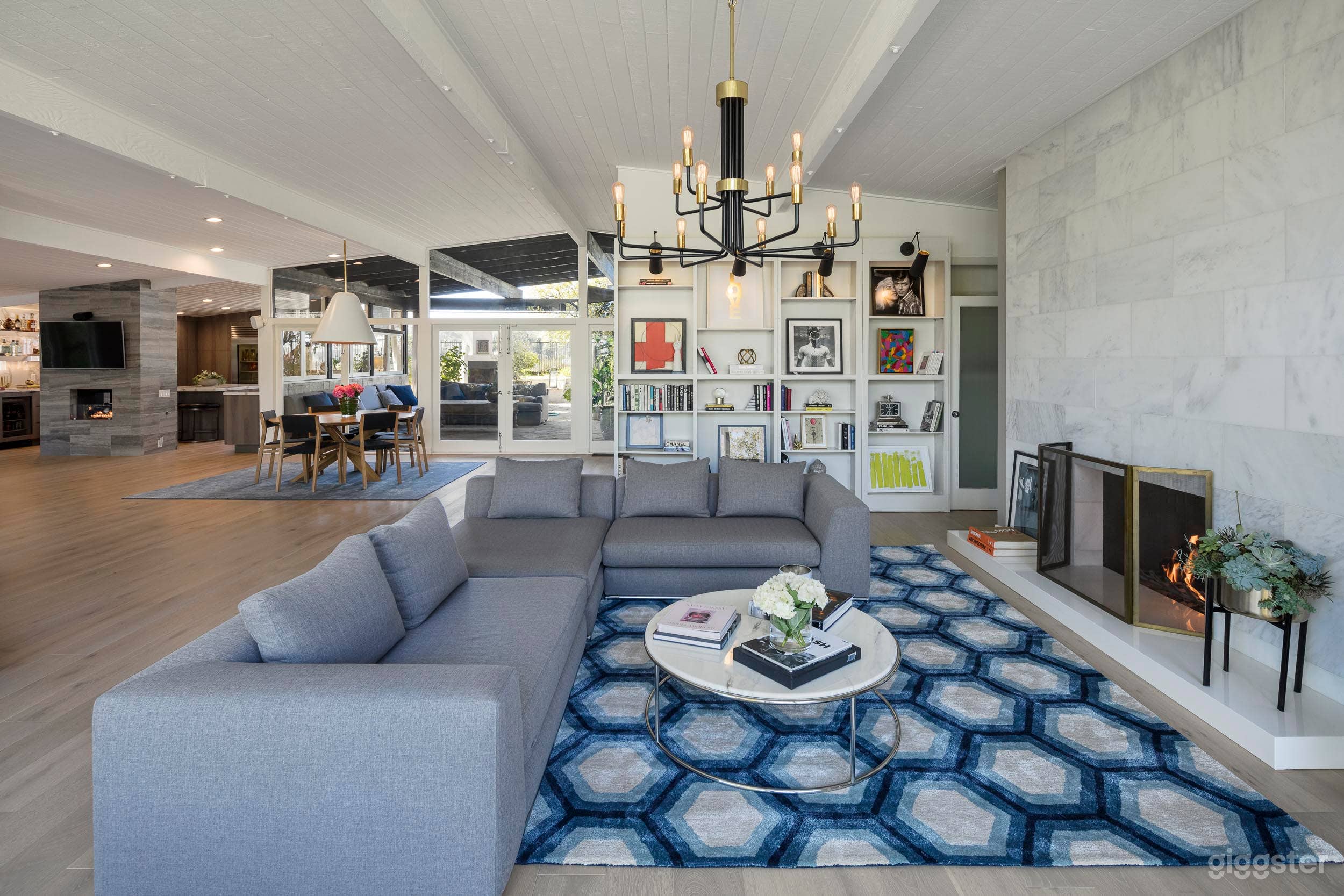 Living room with large marble fireplace and bookcases.