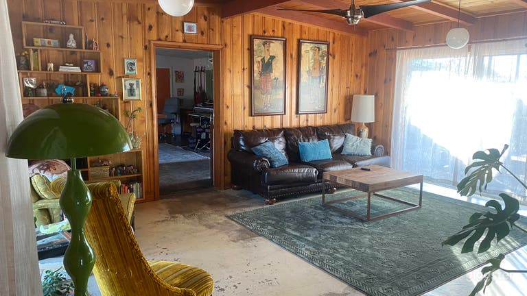  living room, wood panel walls, built in book shelf 