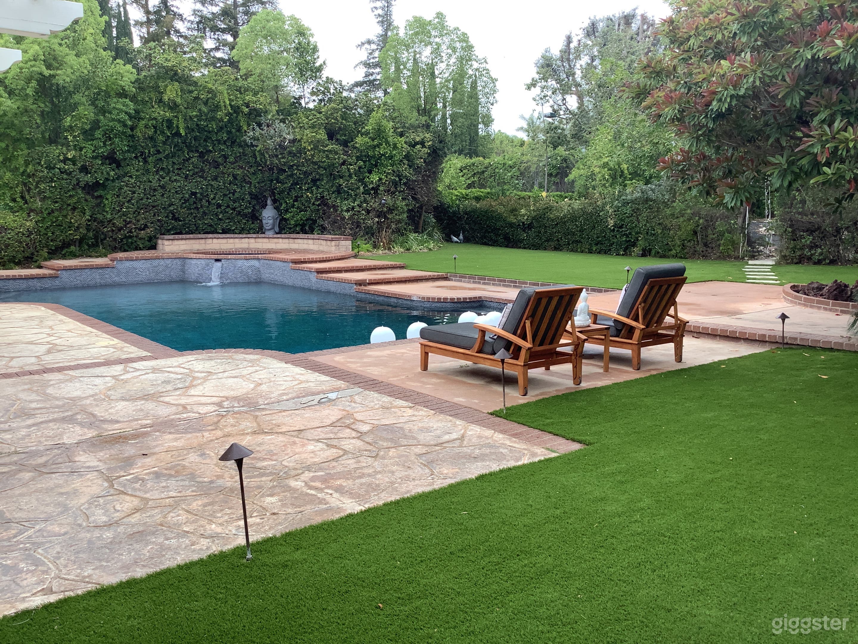 Elegant Backyard Pool Oasis w/ Lush Landscape Photo 1