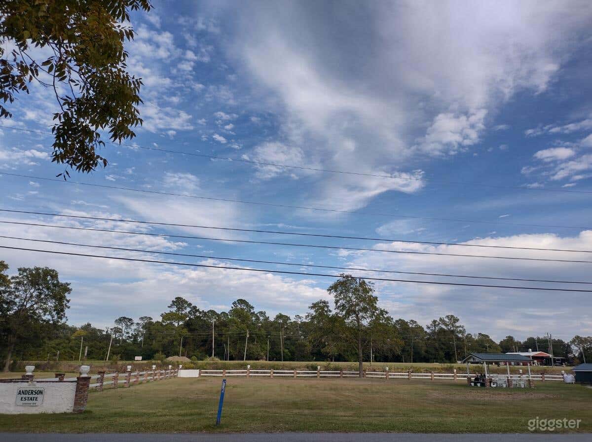 Open space and a Gazebo with rocking chairs and concrete bench