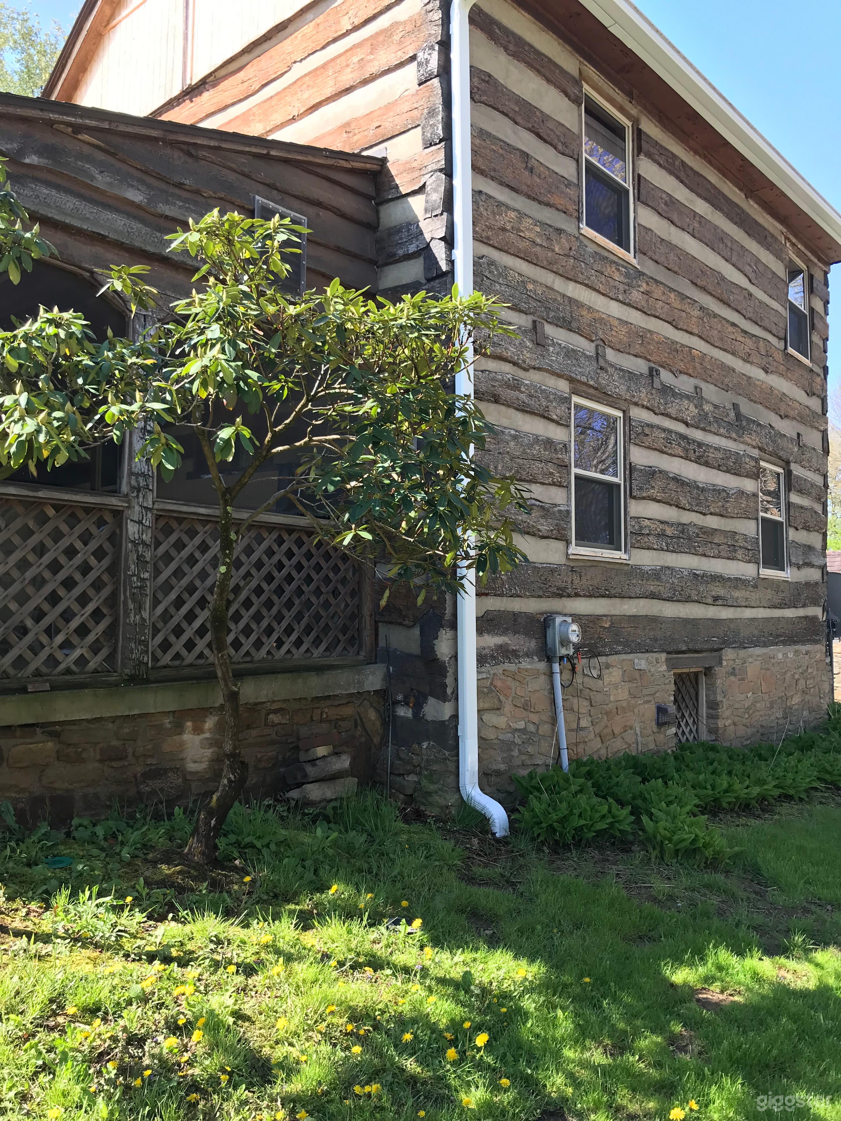 Side of 1800’s farmhouse with screen porch.