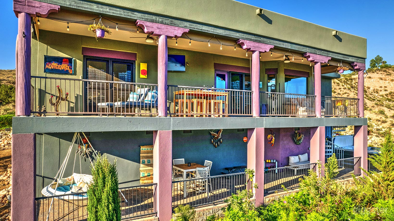 Two outdoor decks with views of farmland, desert and mountain ranges. 