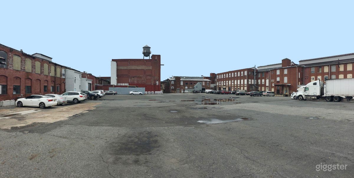 Large parking lot surrounded by old warehouses Photo 1