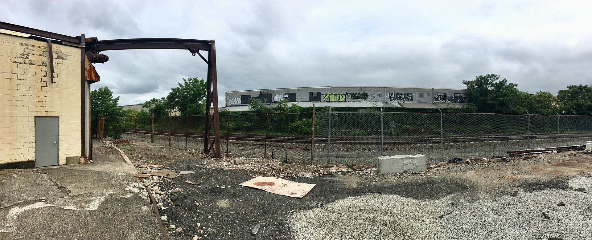 Large parking lot surrounded by old warehouses Photo 3