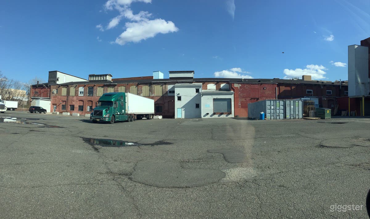 Large parking lot surrounded by old warehouses Photo 4