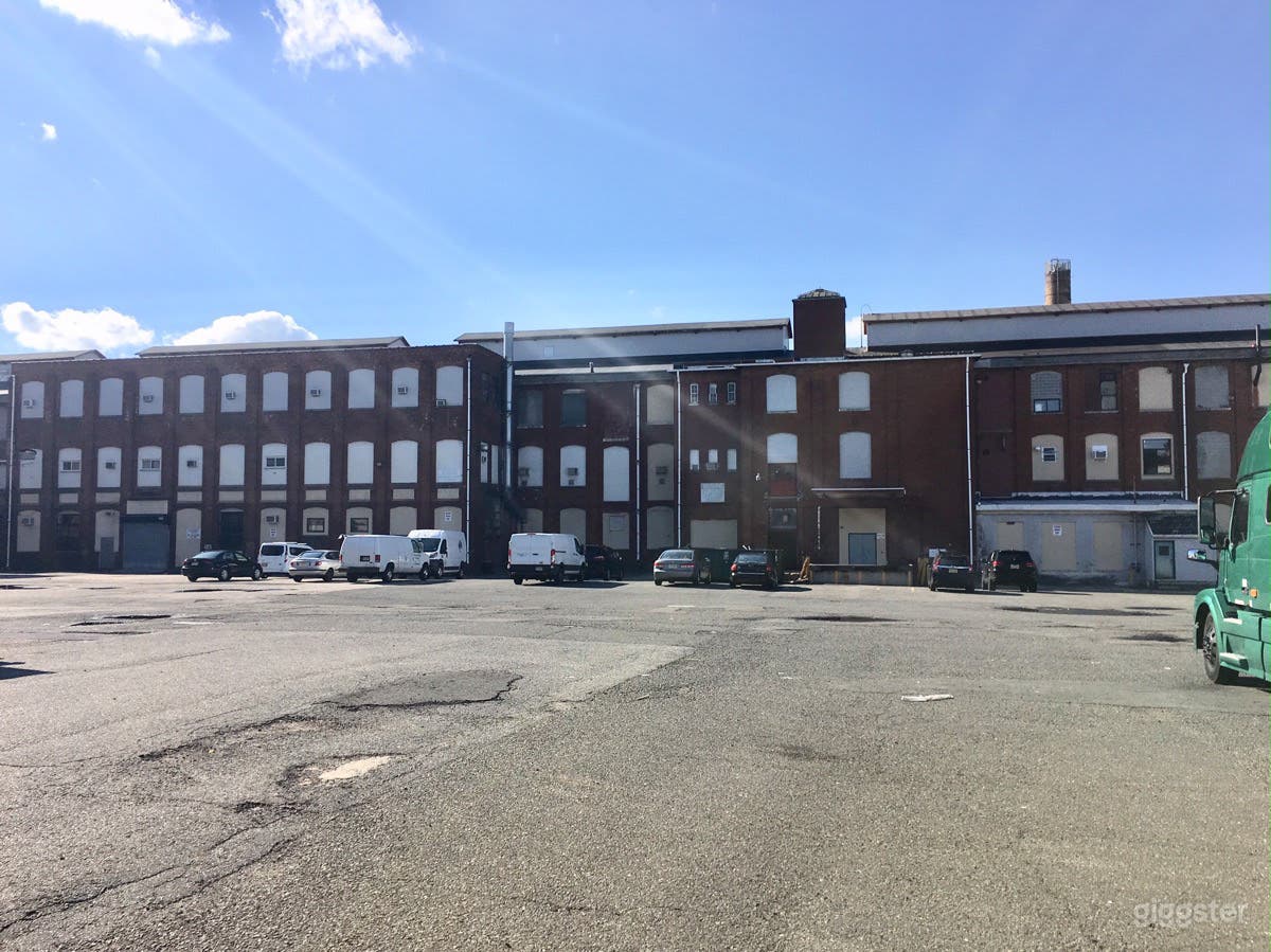 Large parking lot surrounded by old warehouses Photo 2