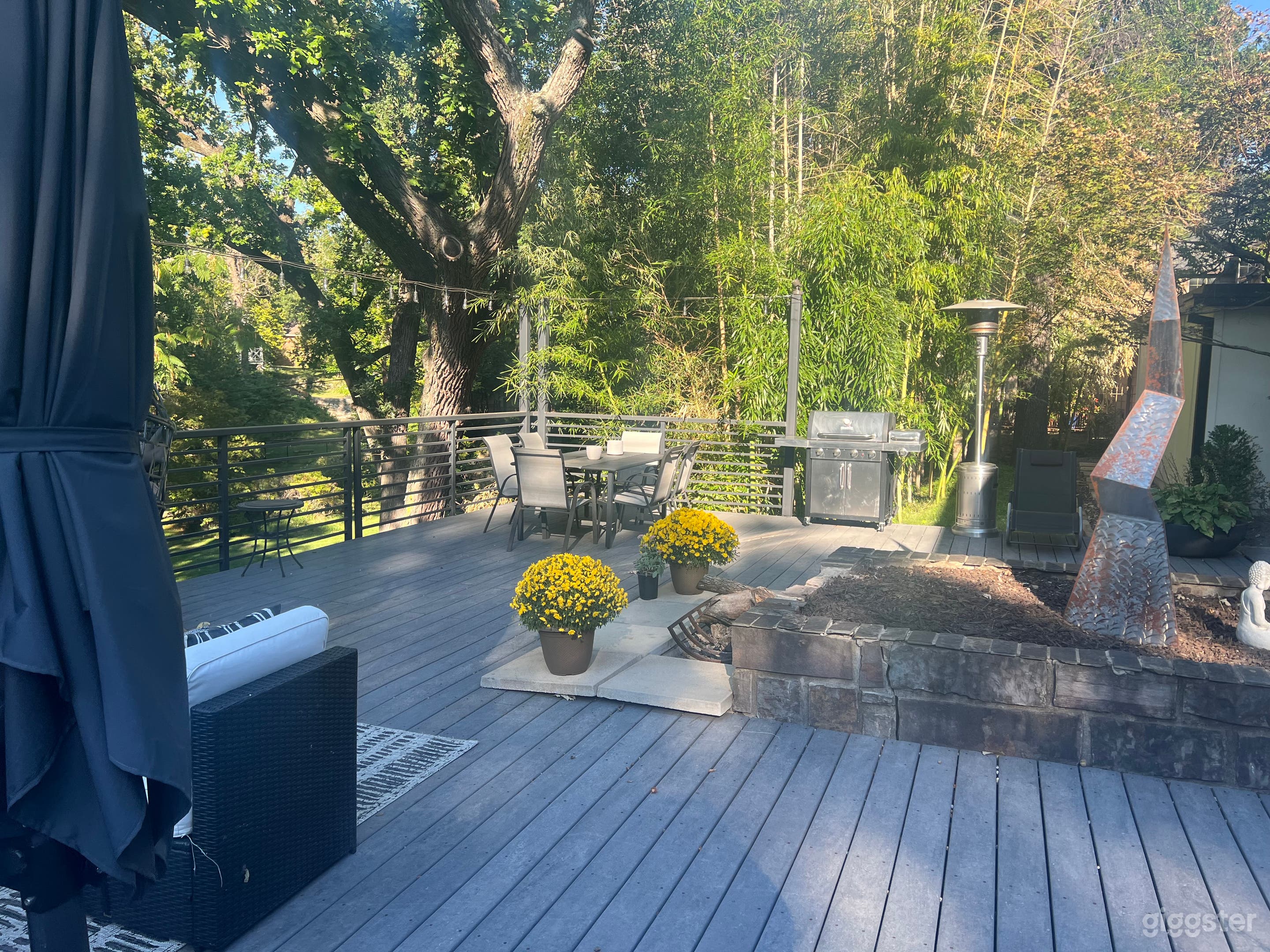 Large park like backyard with deck and beautiful trees