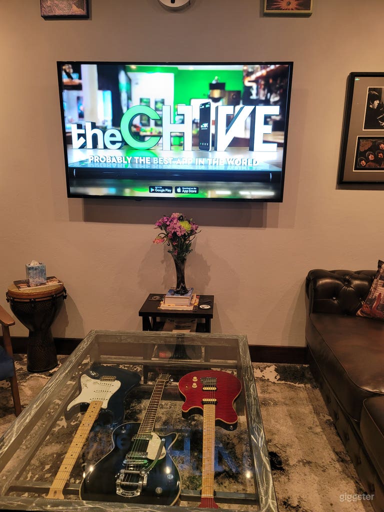  Center media Break room and lounge area has a couch with a glass guitar coffee table, 2 arm chairs, a conference or dining table with 6 adjustable stools, a kitchenette and music themed art. 