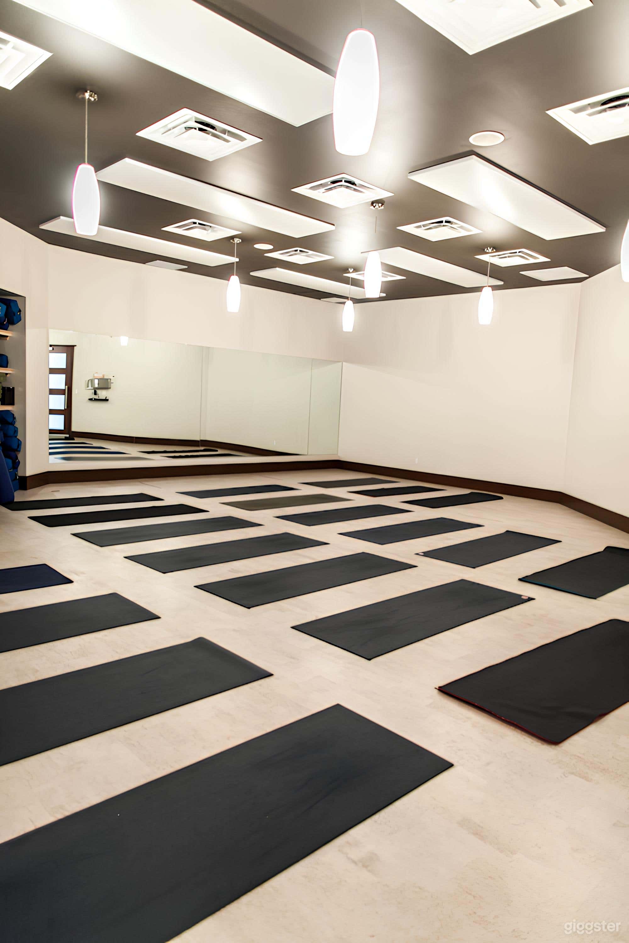 Bright and Spacious Studio: An expansive yoga space with polished wooden floors and clean lines, perfect for filming or hosting intimate workshops.