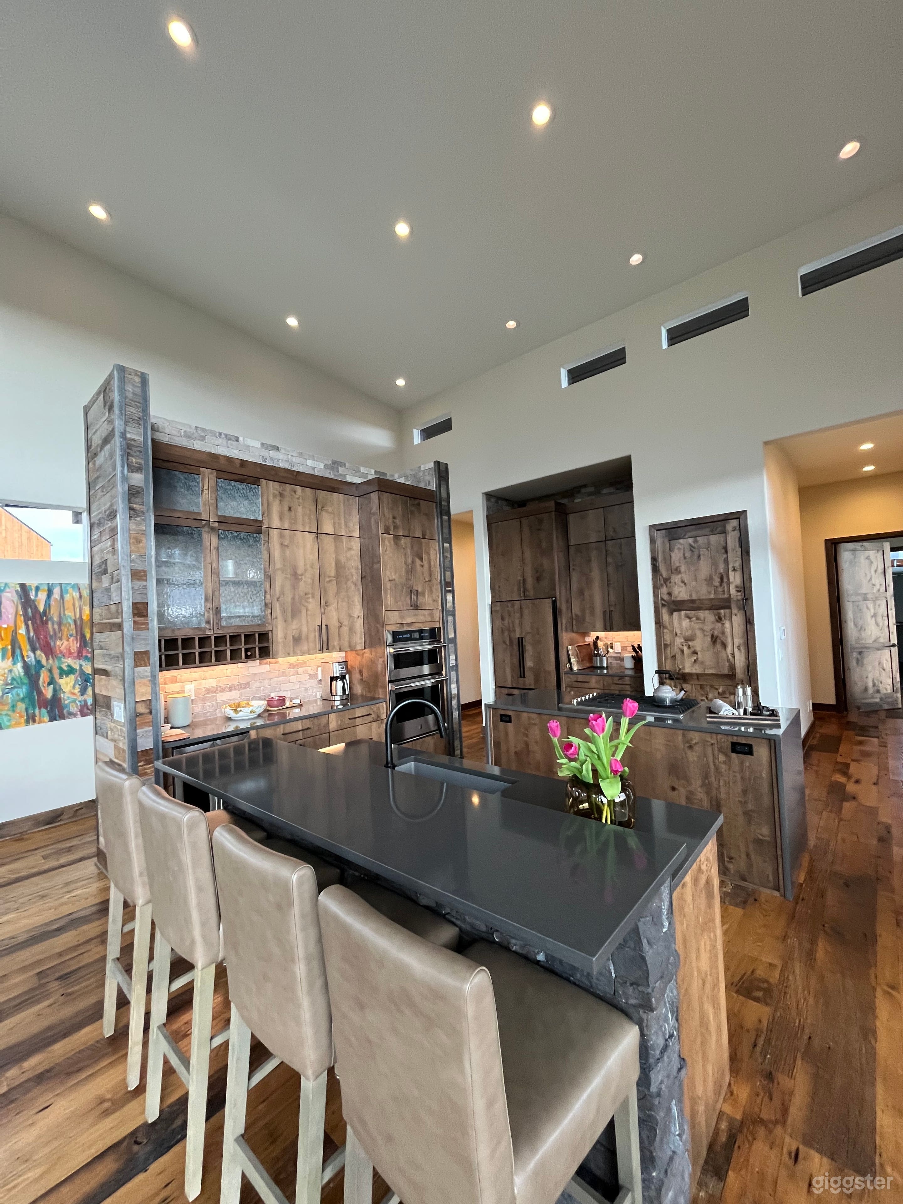 Open plan chef kitchen w double island, quartz counters, pantry, wine fridge, stone backsplash.  Island for 4. 