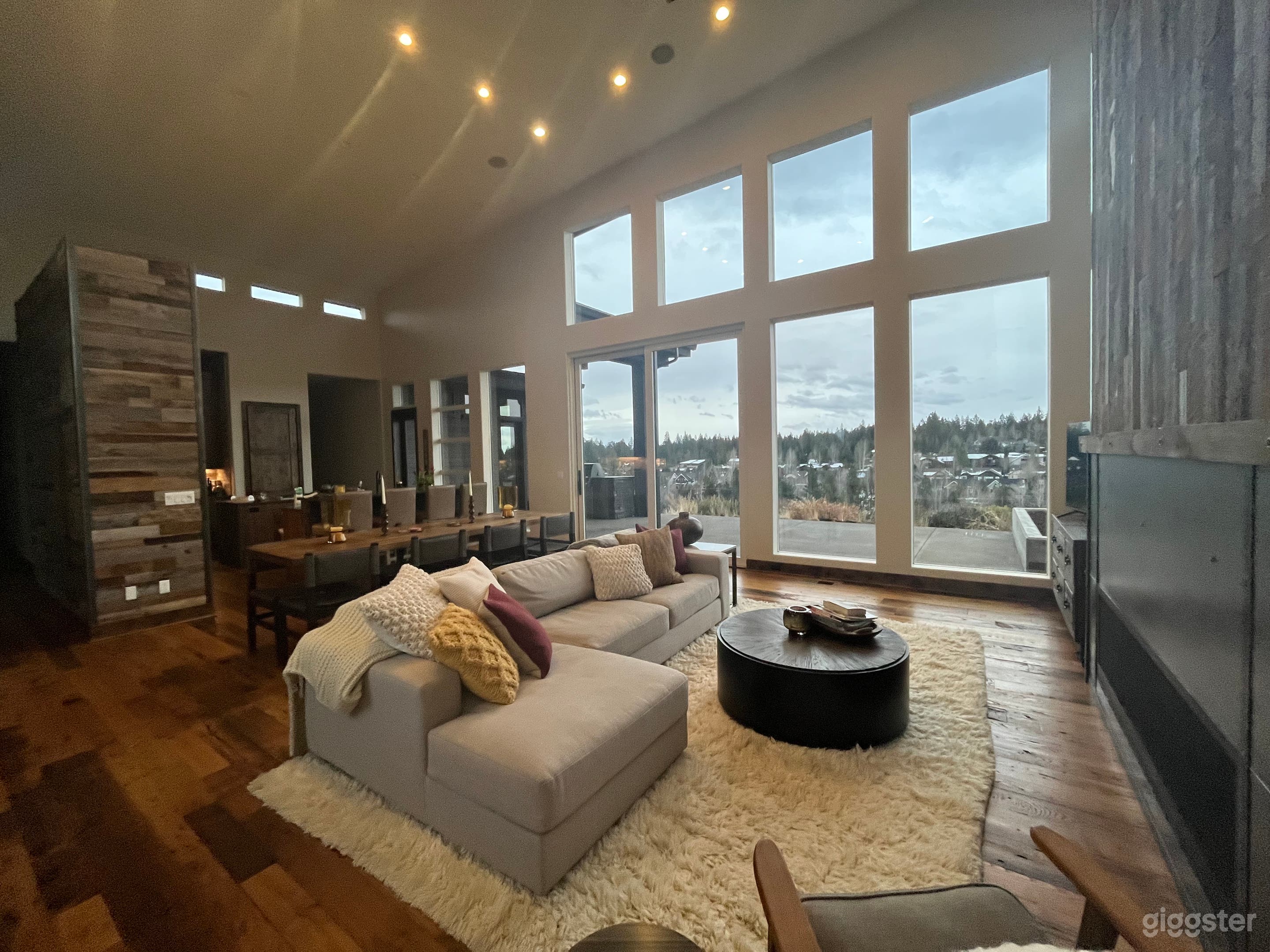 Beautiful open and warm space. 22 feet ceilings.  Gorgeous light.  Right wall is 6 foot gas fireplace in metal and then topped w reclaimed wood feature.  