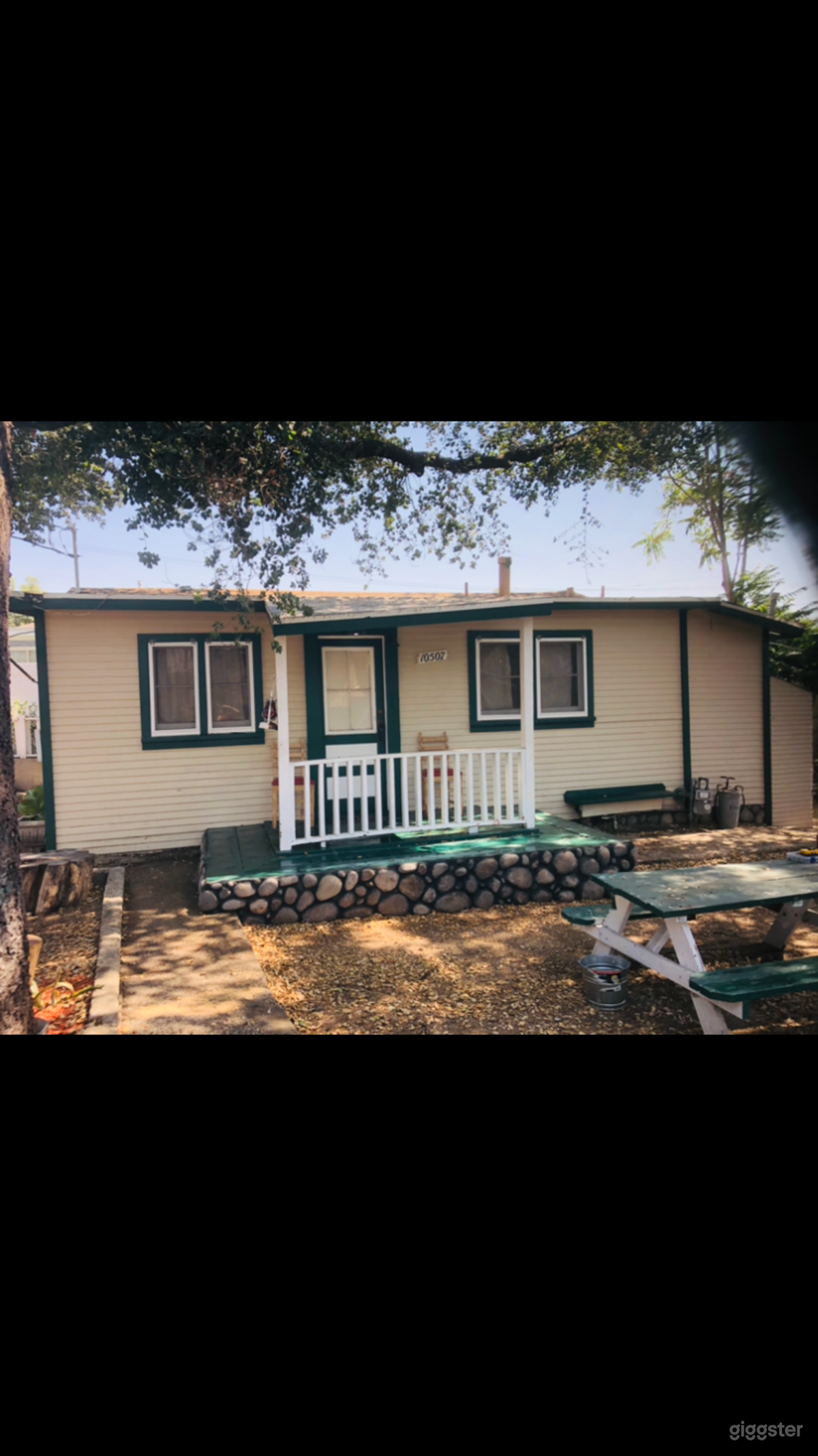 Front of cabin. Has porch and extension, functioning dutch door and casement windows.