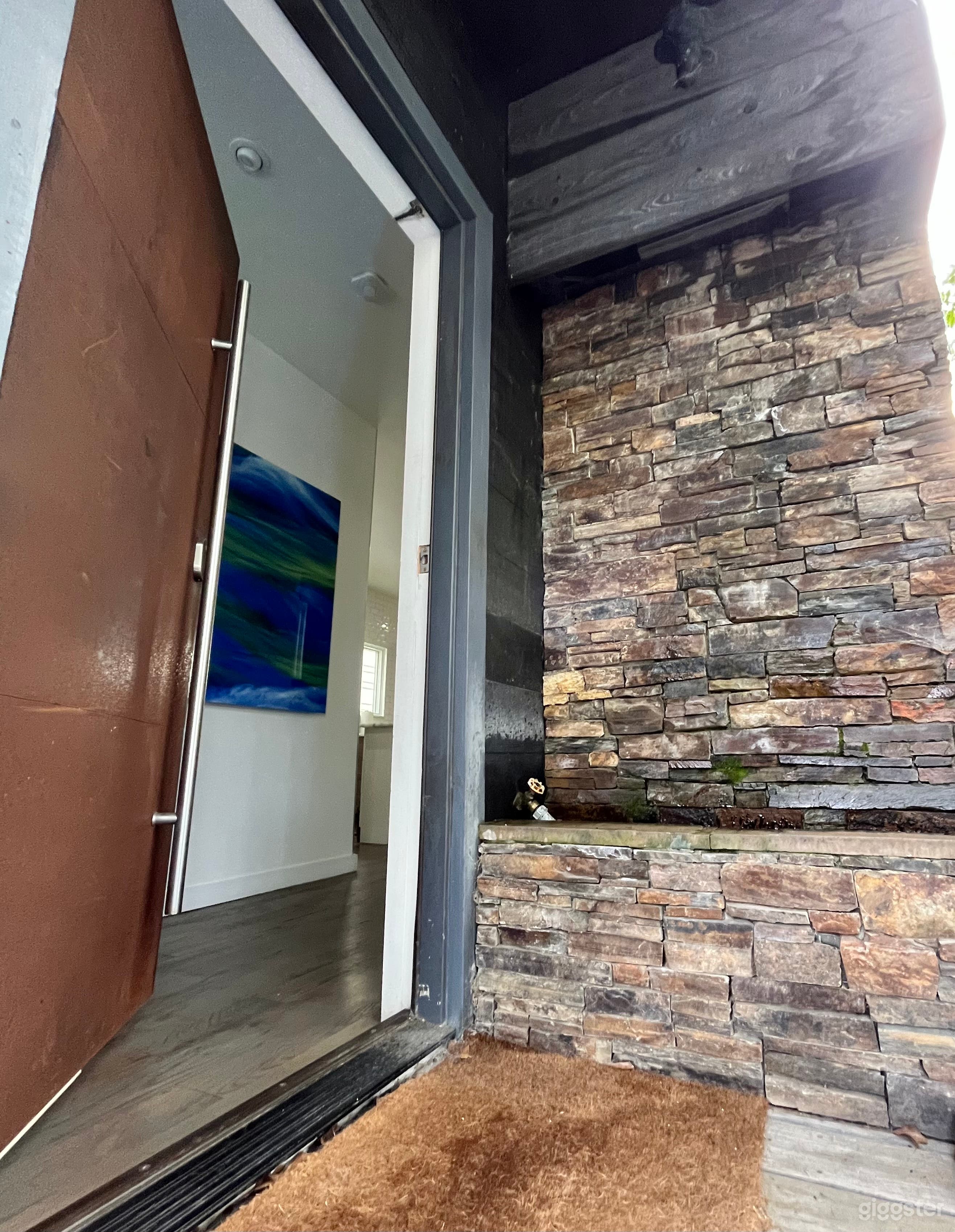 Front door waterfall wall &amp; industrial metal door.