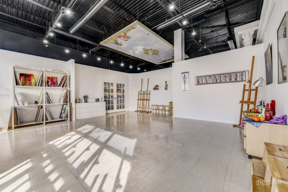 A stunning and spacious studio with bright white walls. Paintings on walls will vary and are painted by the owners of the school, typically.