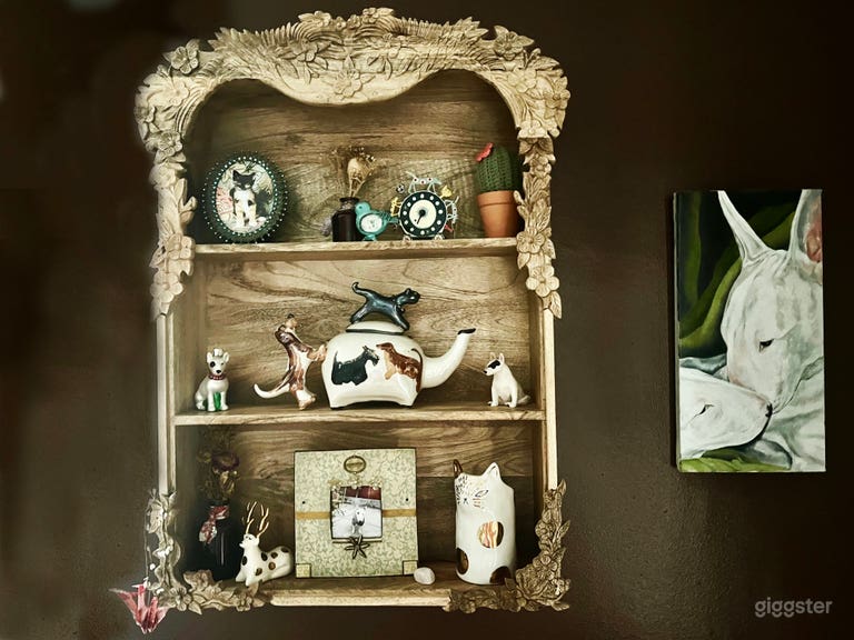  Detail of vintage cabinet with small treasures and painting of 2 Bull terriers  