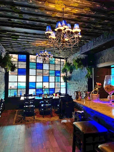 Dark-themed Event Space with Bar Photo 4
