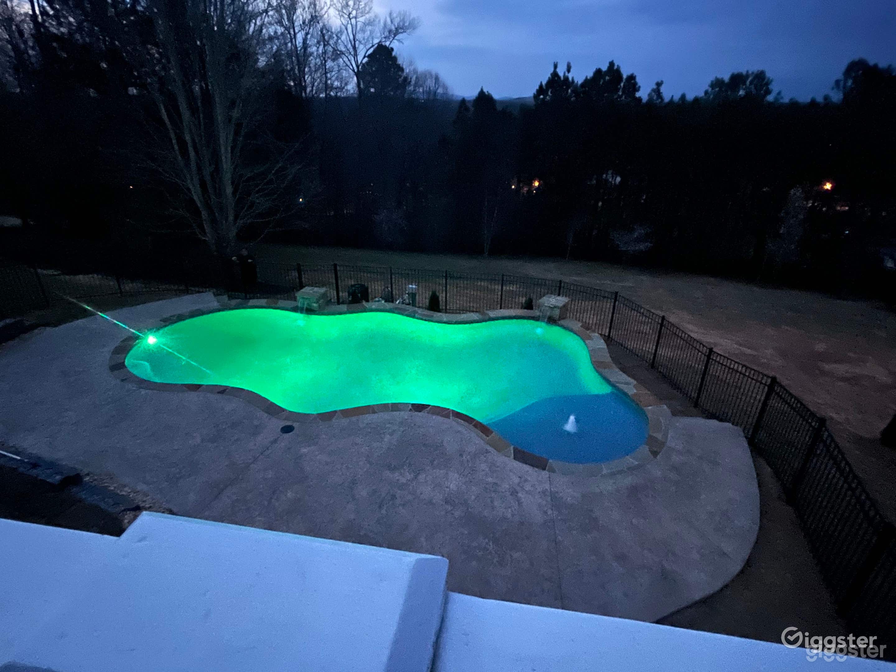 An outdoor pool in a serene oasis  Photo 1