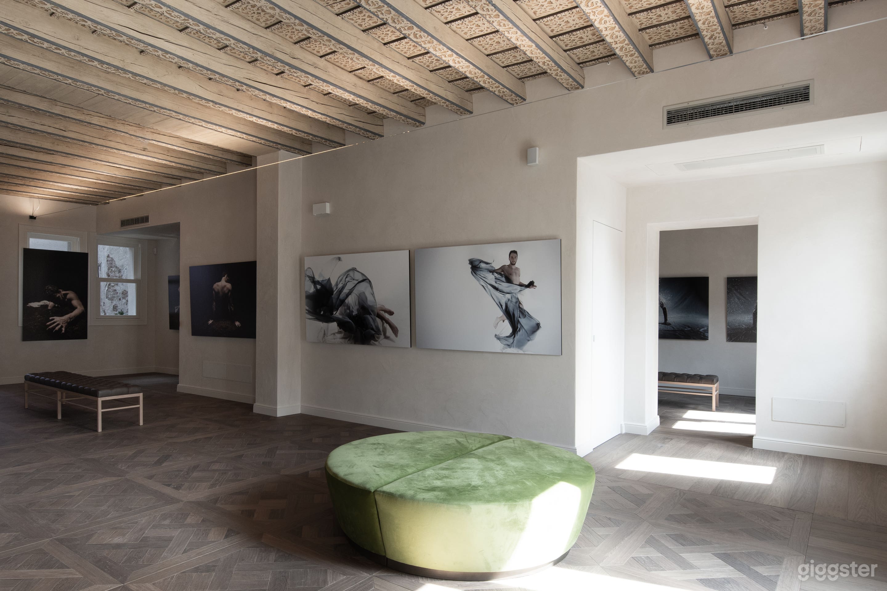 This refined space seamlessly blends historic charm with modern elegance. Bathed in natural light, it features striking contemporary artwork and a picturesque balcony, creating an inspiring setting for gatherings, photo shoots, and film productions.