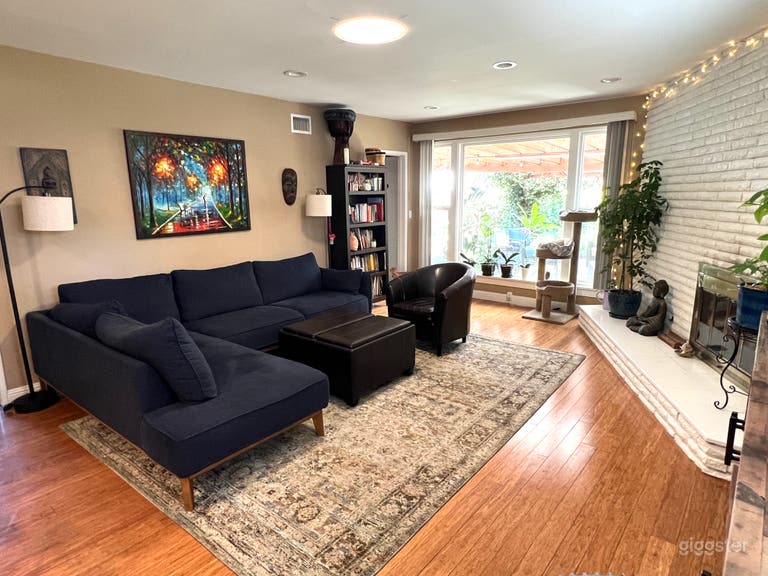  Family room has fireplace on the right and hardwood floors. Large picture window looks into backyard. 