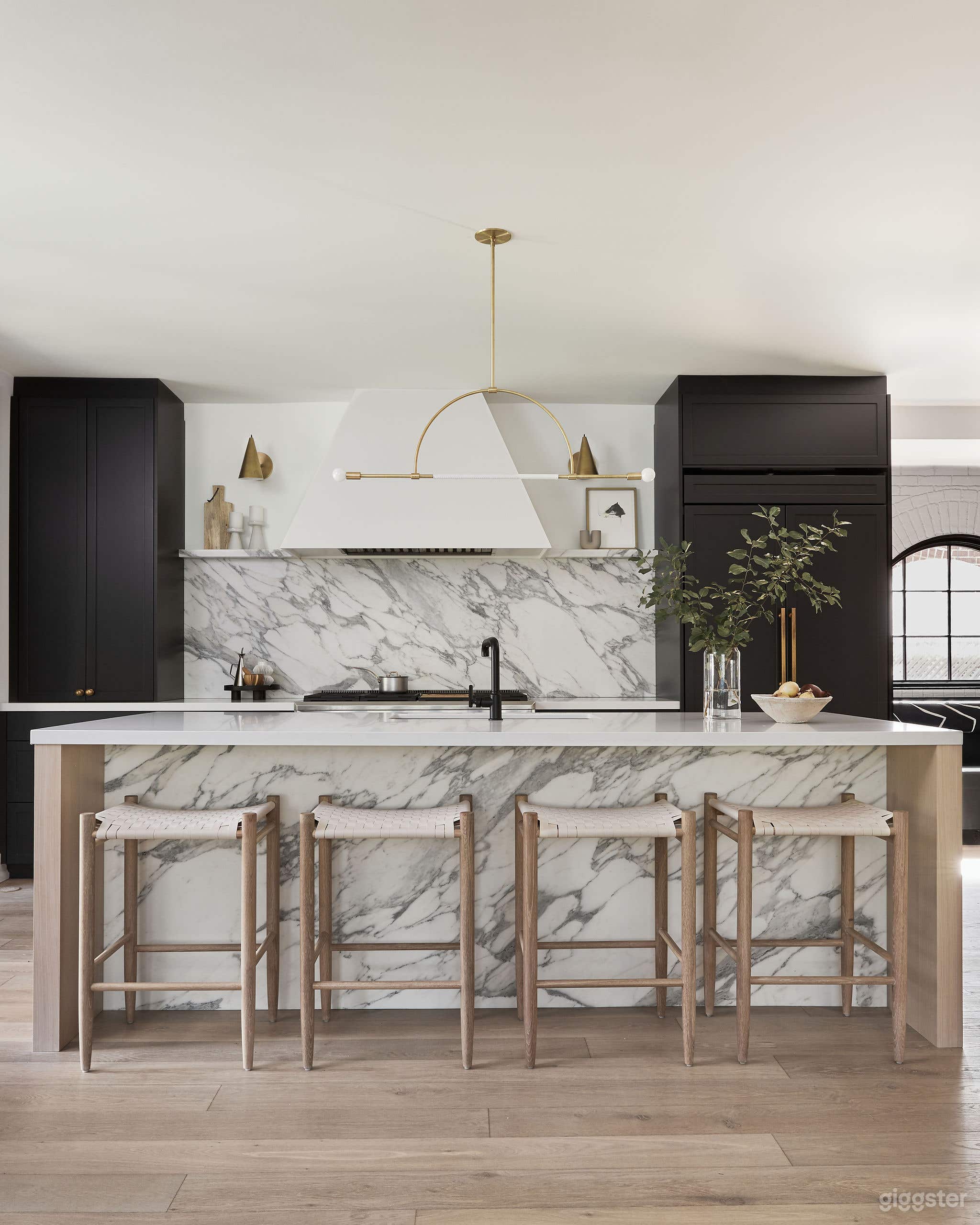 Kitchen with Island and Breakfast Nook under Arched Window