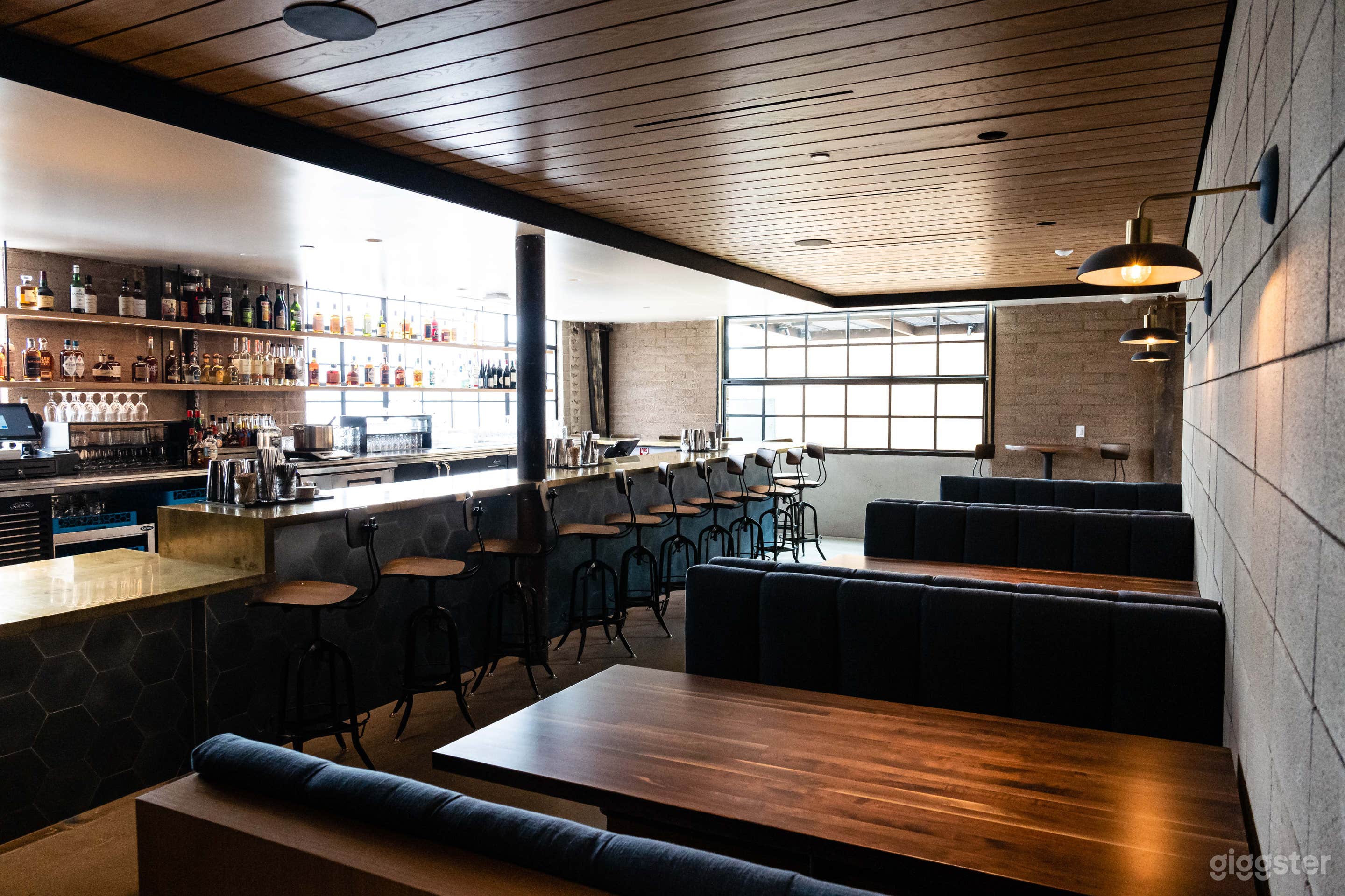 Cozy bar featuring a 10 seat bar and three booths 