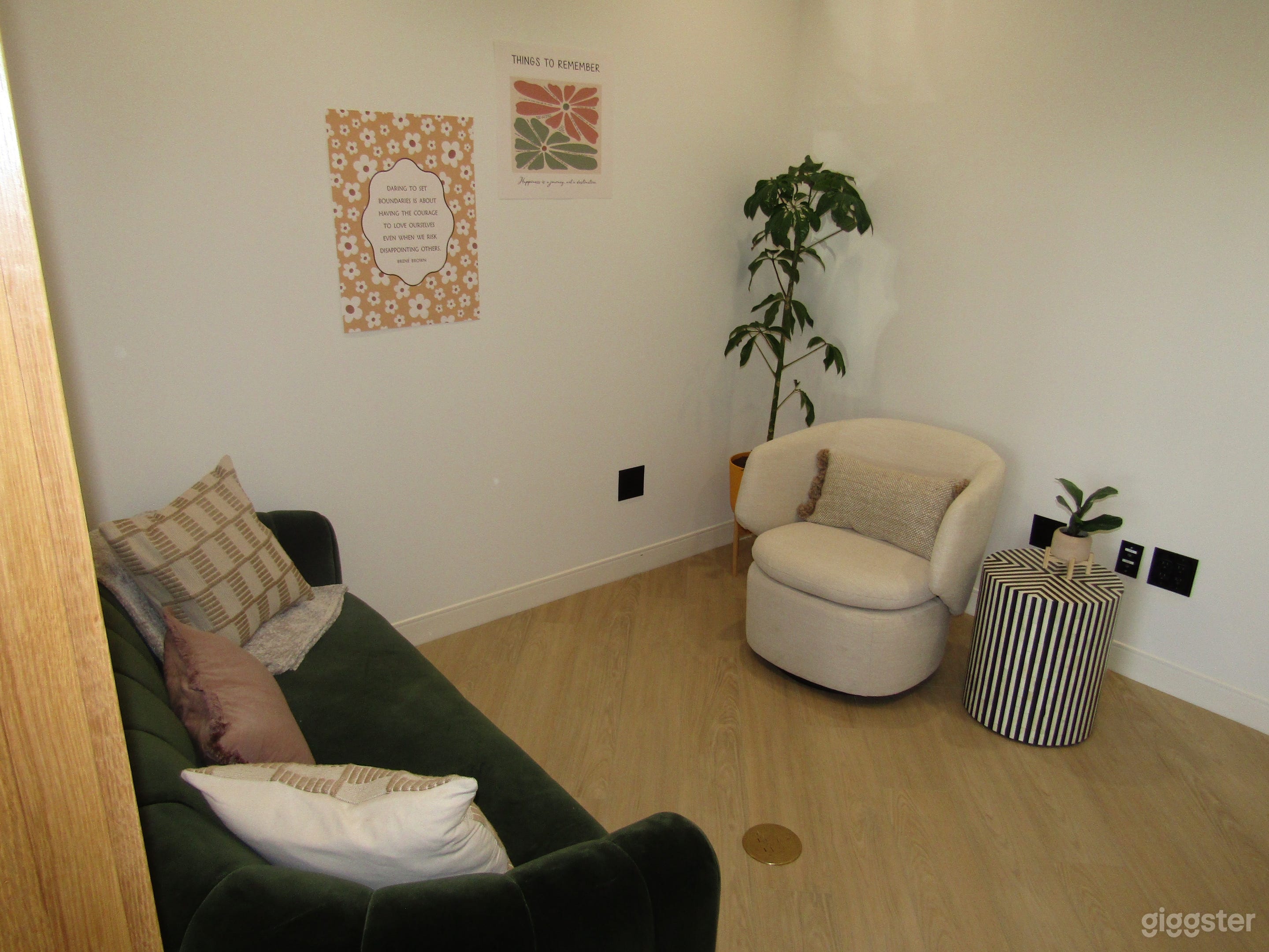 Comfortable private office with a sofa, accent chair, and plant décor