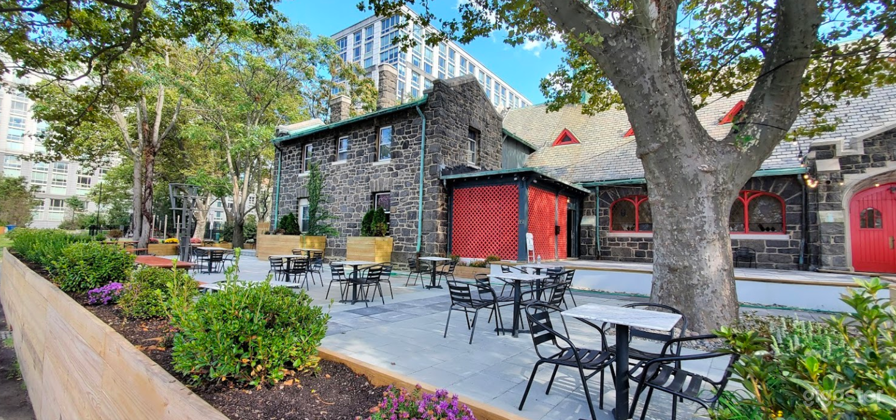 View of bi-level front patio space and house attached to church