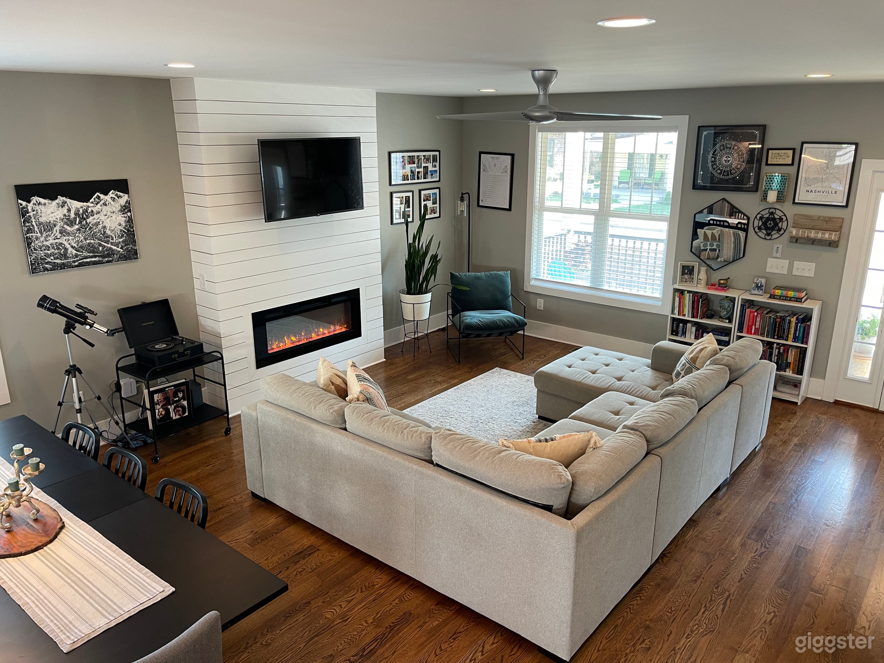 Open-concept living area with ample natural light (wall decor can be removed).