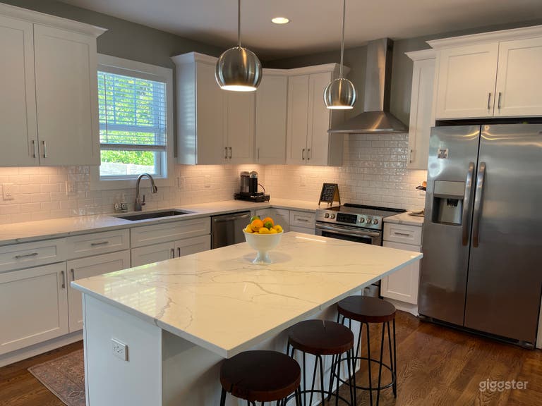  Stunning, timeless kitchen with quartz countertops + stainless steel appliances and hardwood floors throughout. 