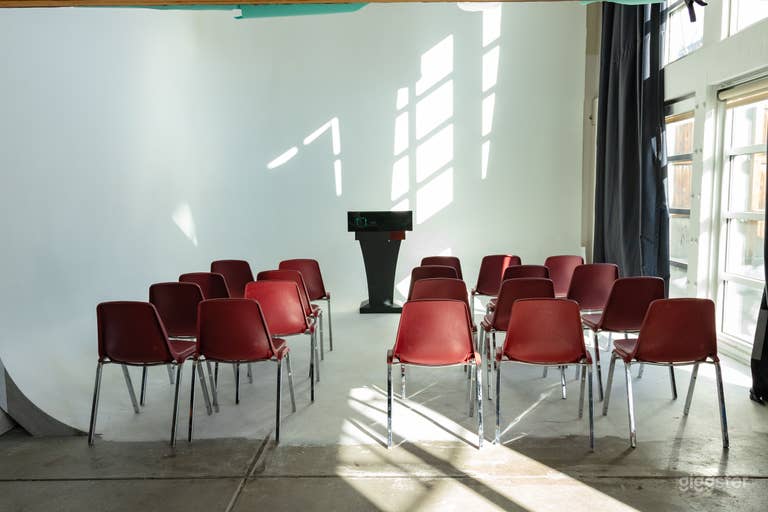  This space can be suited for events and presentations. We have a projector mounted to project onto the cyc wall behind the podium 