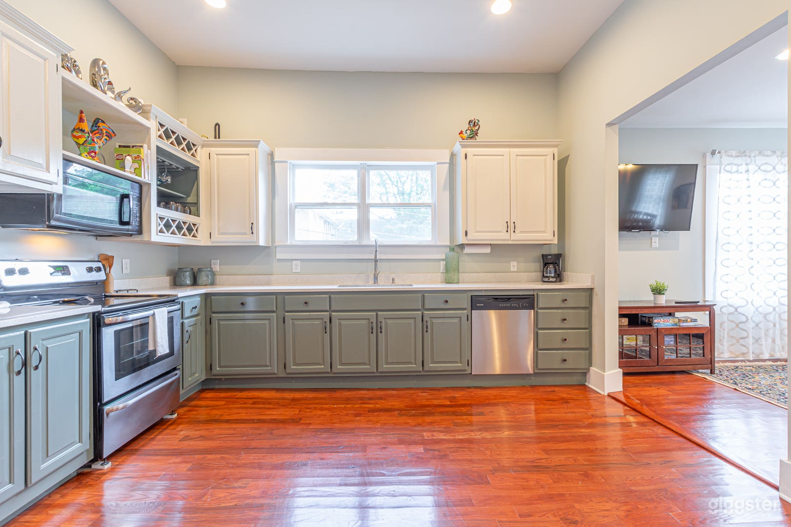 The kitchen is large with high ceilings and original windows, and fully stocked.