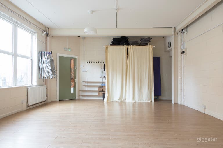  View of storage area at end of room, kitchenette off to back R corner (also fire exit). Shelves no longer curtained.  