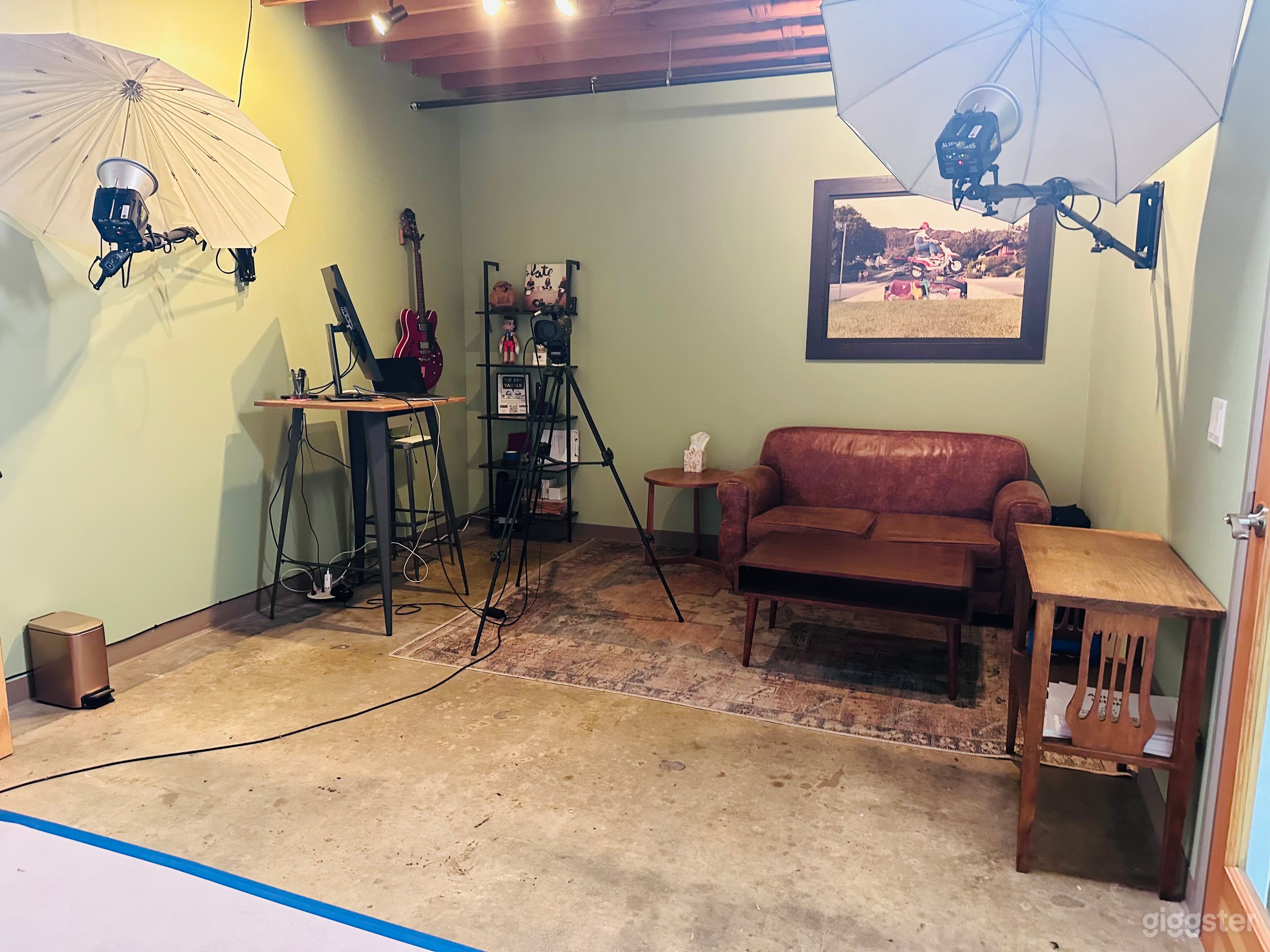 Living room style studio with love seat and equipment for photo/video.