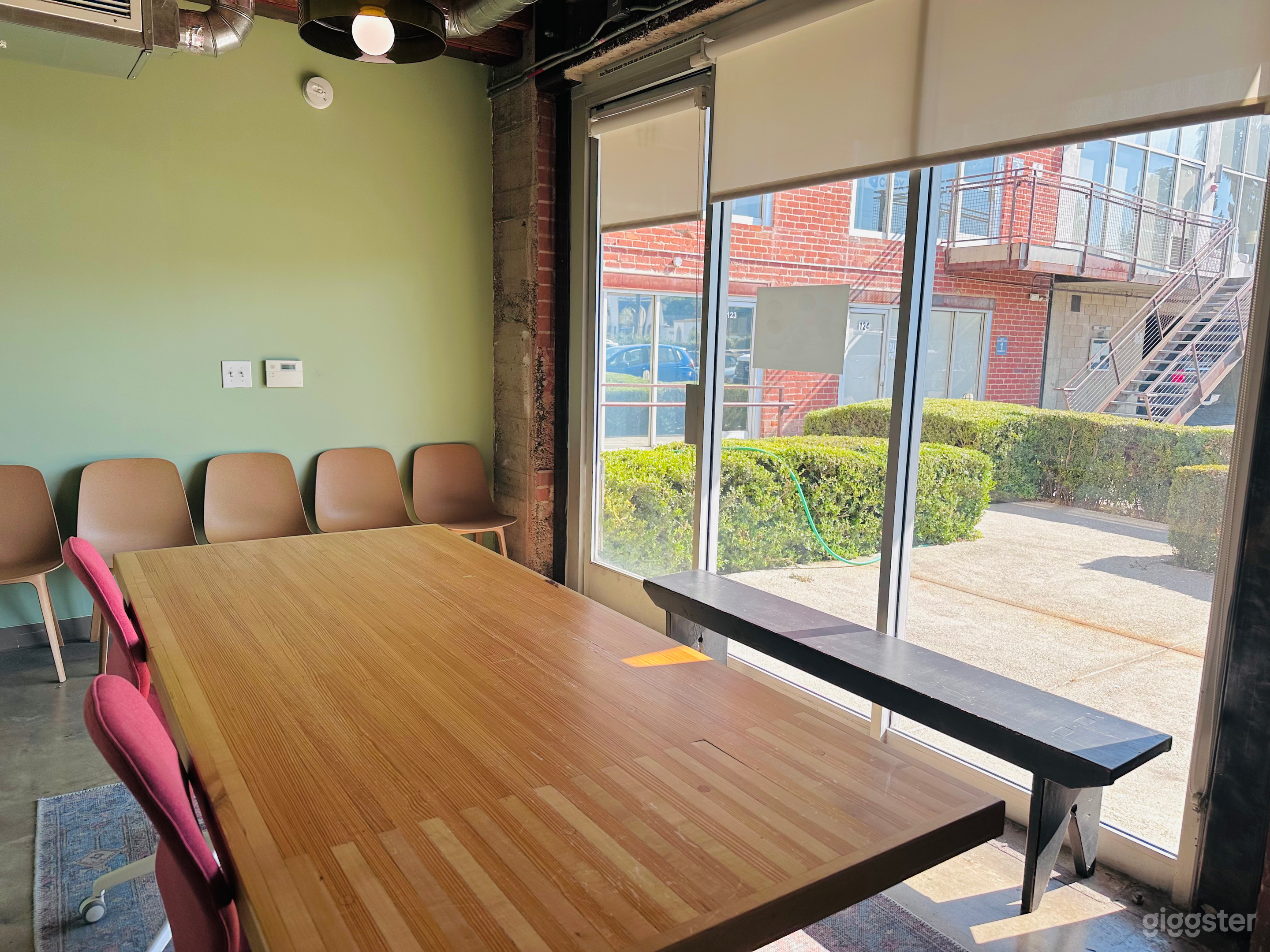 Entry with natural light, seating, and big work table.