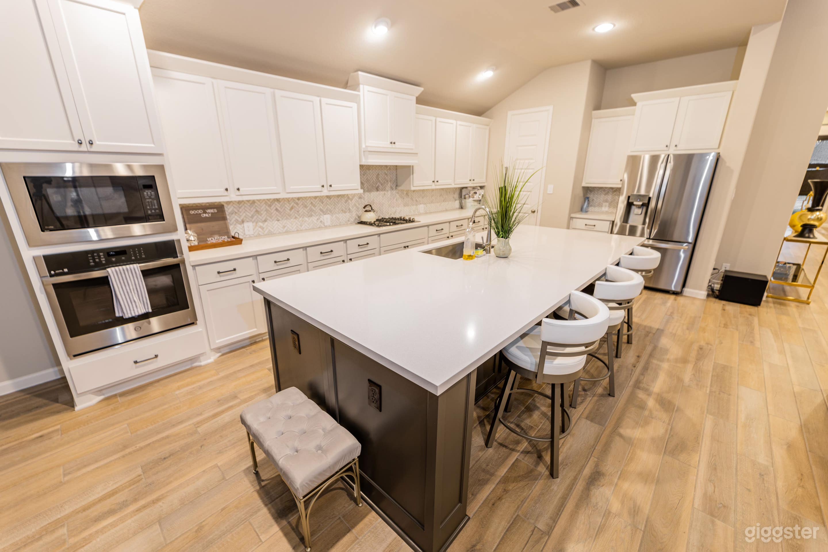 Long white marble kitchen island, perfect for hosting dinner parties alongside the naturally lit adjoining dinning area