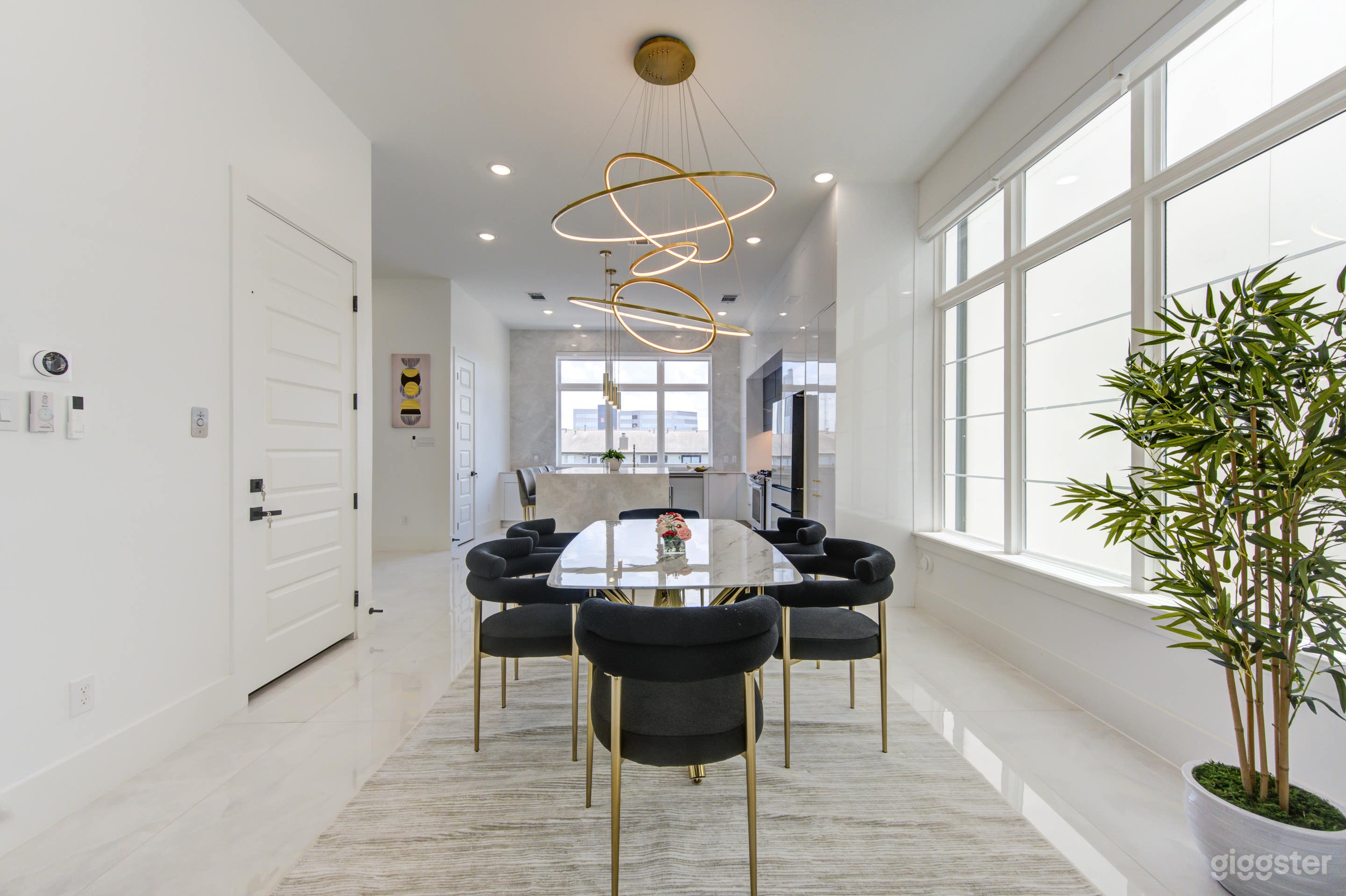 Large dining room with modern chandelier and dimmable lights